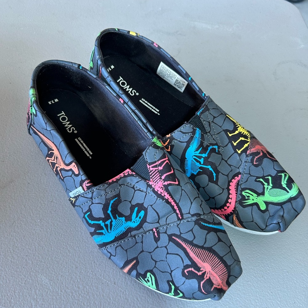 TOMS Black Slip-Ons with Colorful Dinosaur Design